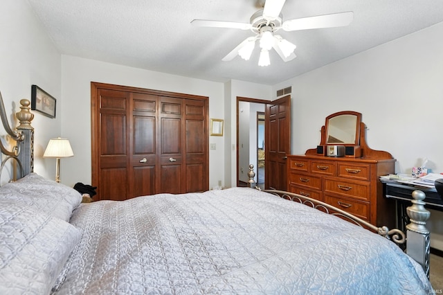 bedroom with a closet, visible vents, ceiling fan, and carpet floors