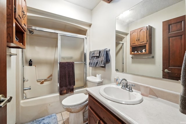 bathroom with toilet, vanity, a textured ceiling, tile patterned floors, and bath / shower combo with glass door