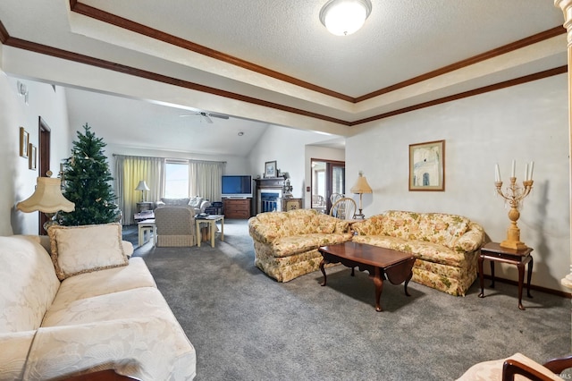 carpeted living room featuring a ceiling fan, a raised ceiling, ornamental molding, and a textured ceiling