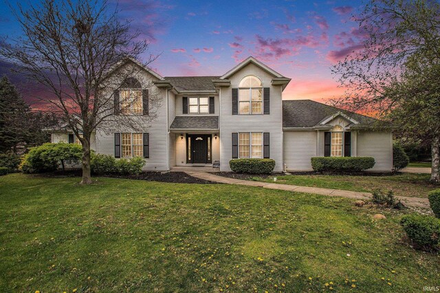21521 Cheri Ln, Bristol, IN 46507 - traditional-style home featuring roof with shingles and a front lawn