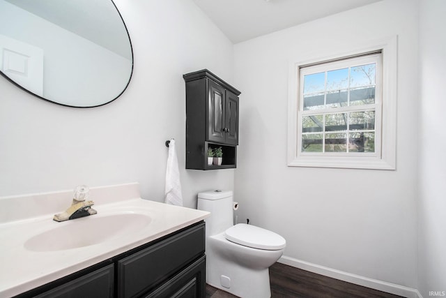 21521 Cheri Ln, Bristol, IN 46507 - half bath featuring vanity, toilet, baseboards, and wood finished floors