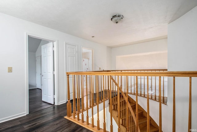 21521 Cheri Ln, Bristol, IN 46507 - corridor featuring baseboards, dark wood-type flooring, and an upstairs landing