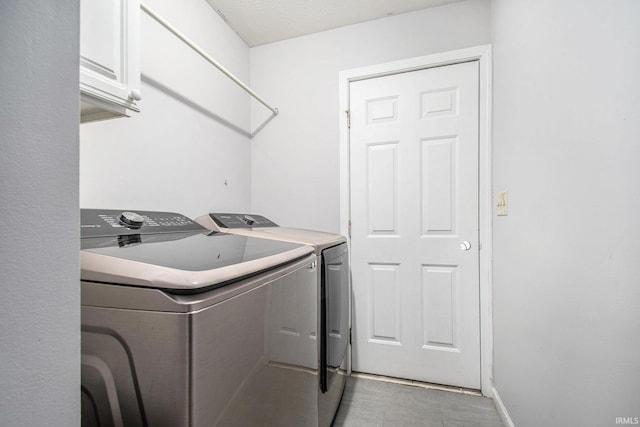 21521 Cheri Ln, Bristol, IN 46507 - laundry area with washing machine and clothes dryer and cabinet space