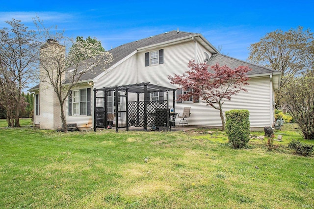 21521 Cheri Ln, Bristol, IN 46507 - rear view of house with a patio, a chimney, a pergola, a shingled roof, and a yard
