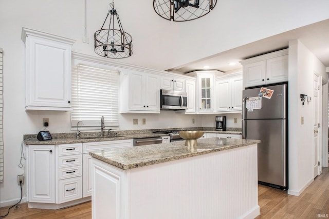 21521 Cheri Ln, Bristol, IN 46507 - kitchen featuring light wood-style floors, stainless steel appliances, white cabinets, and a sink