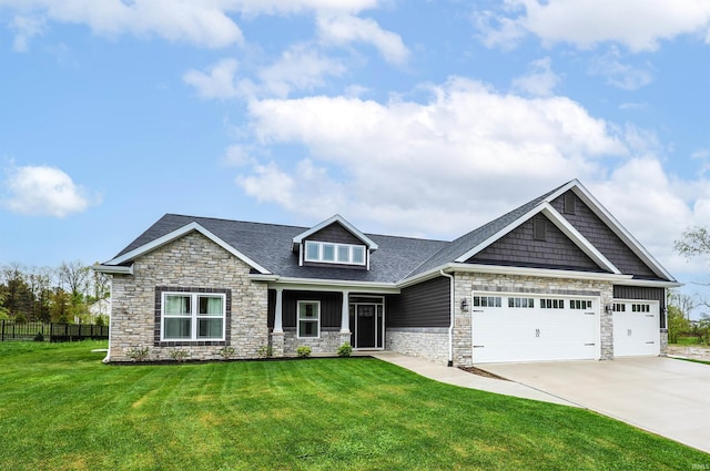 craftsman house featuring stone siding, an attached garage, fence, and a front yard