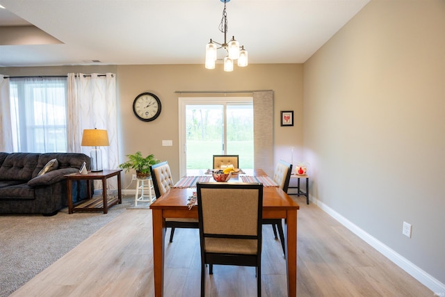 dining area featuring a chandelier, a healthy amount of sunlight, and light wood-style floors