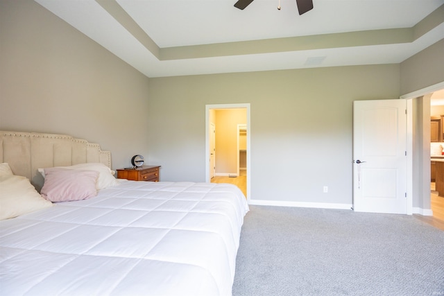 bedroom with light colored carpet, baseboards, and a ceiling fan