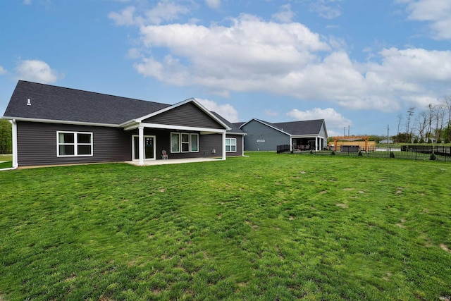 back of house with a lawn, a patio area, and fence