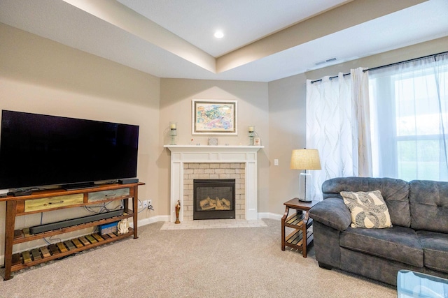carpeted living area with baseboards, recessed lighting, a fireplace, and visible vents