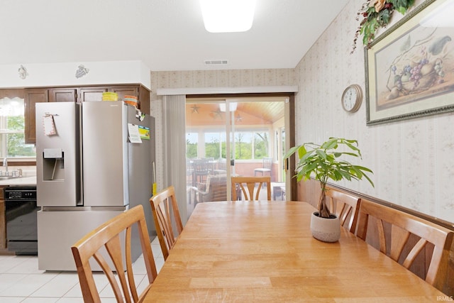 dining room featuring a wealth of natural light, wallpapered walls, and visible vents