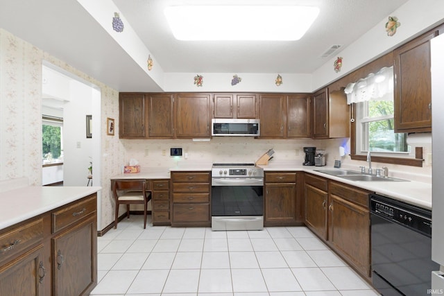 kitchen with light countertops, visible vents, appliances with stainless steel finishes, and a sink