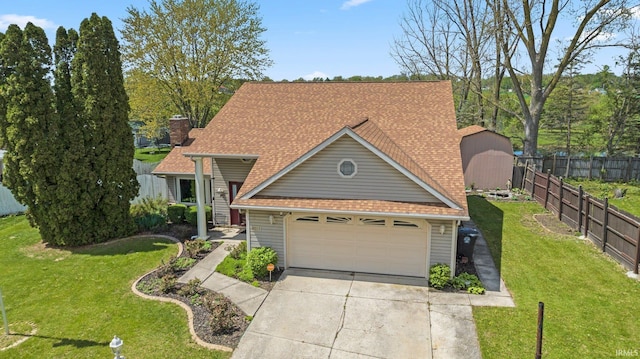 traditional-style house with fence, driveway, a garage, a front lawn, and a shingled roof