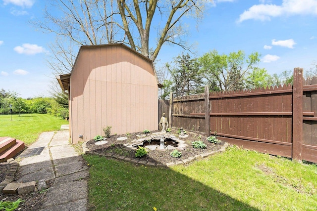 view of yard with an outdoor structure, fence, and a shed
