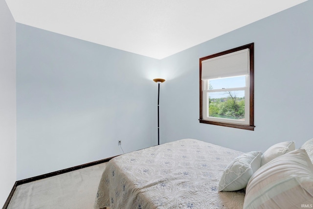 carpeted bedroom featuring baseboards