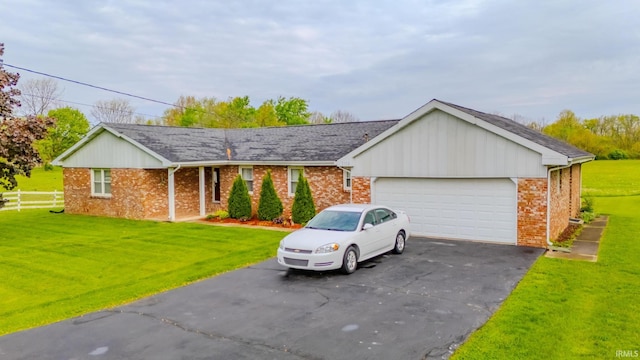 1112 W Walnut St, Summitville, IN 46070 - ranch-style house with a front yard, brick siding, and a garage