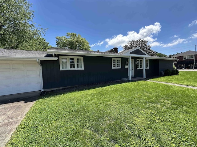 ranch-style house with a chimney, driveway, a front lawn, and a garage
