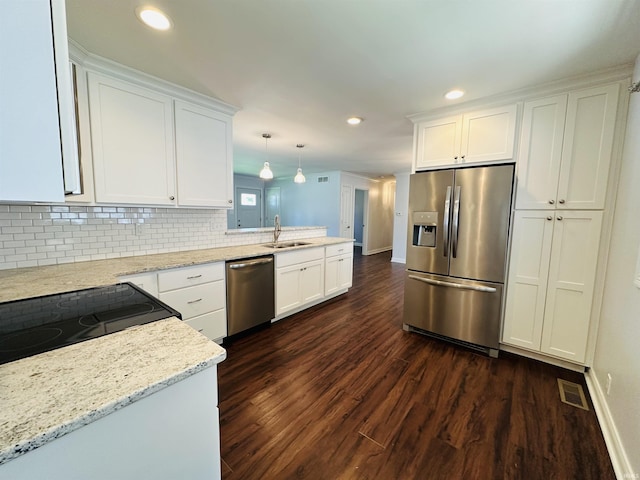 kitchen with white cabinetry, dark wood-style flooring, a peninsula, and appliances with stainless steel finishes