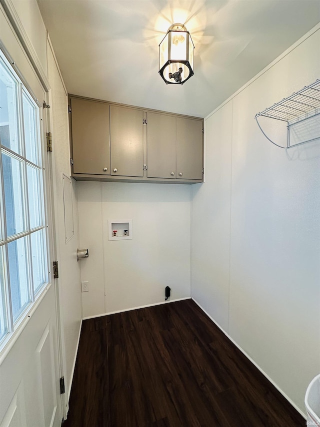 clothes washing area with cabinet space, a wealth of natural light, dark wood-type flooring, and hookup for a washing machine