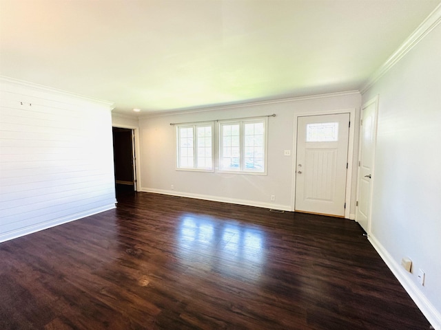 foyer with ornamental molding, a healthy amount of sunlight, and wood finished floors