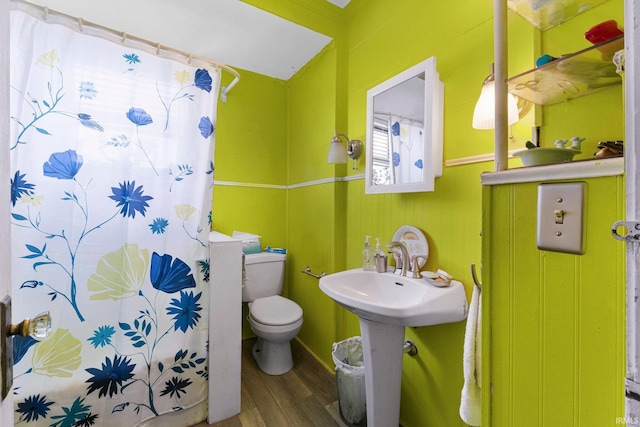 full bathroom with toilet, curtained shower, and wood finished floors