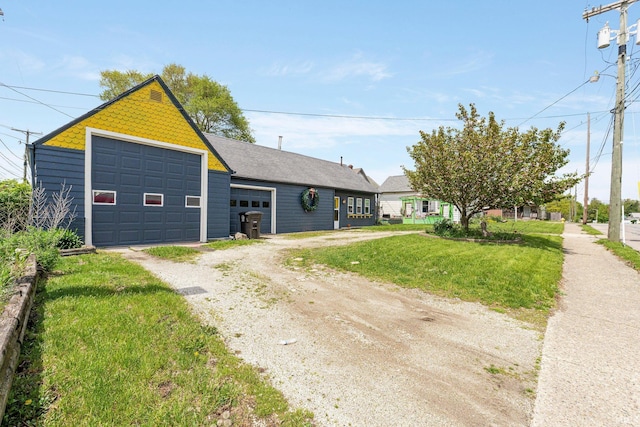 single story home with driveway and a front lawn