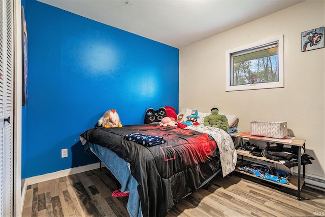 bedroom featuring baseboards and wood finished floors