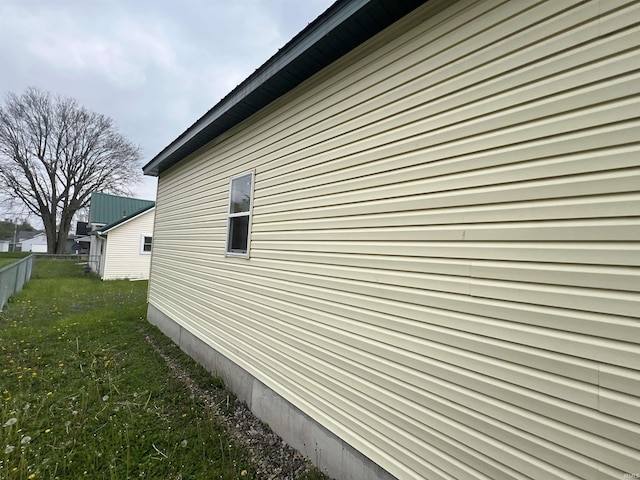 view of home's exterior with a yard and fence