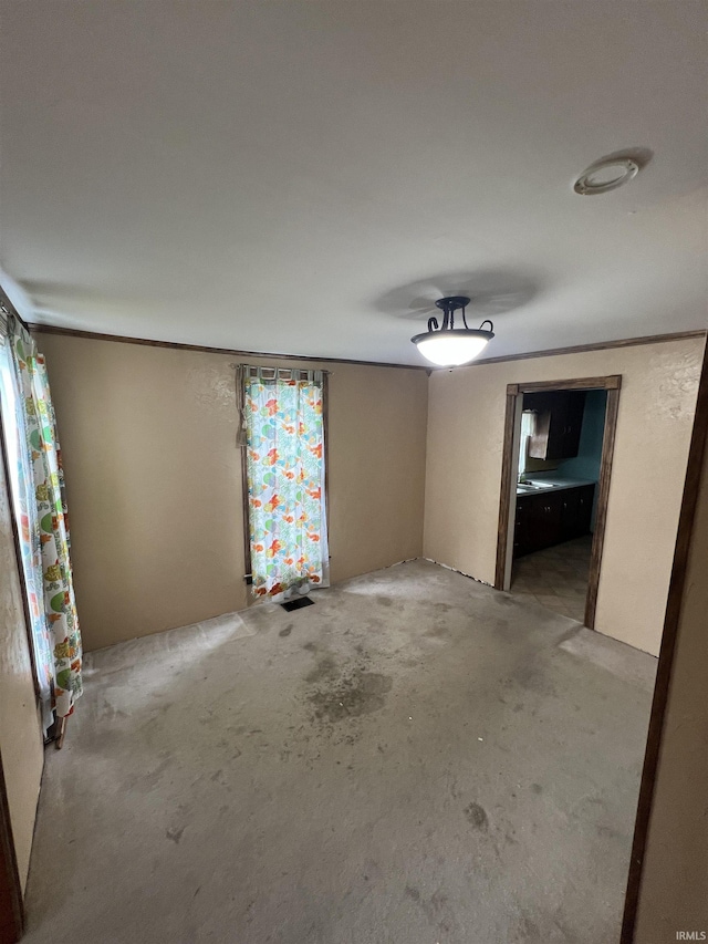 unfurnished room with unfinished concrete flooring