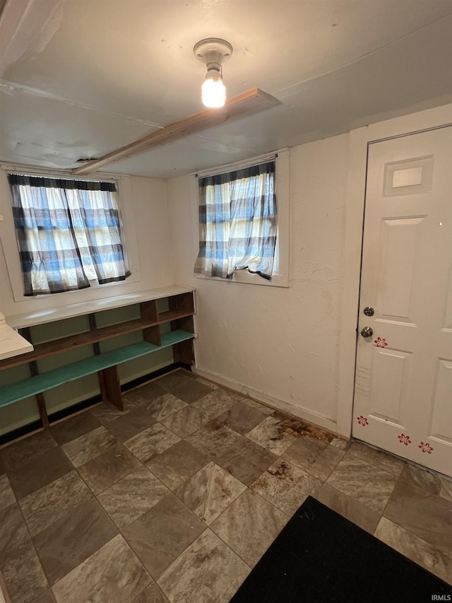 entryway featuring plenty of natural light and baseboards