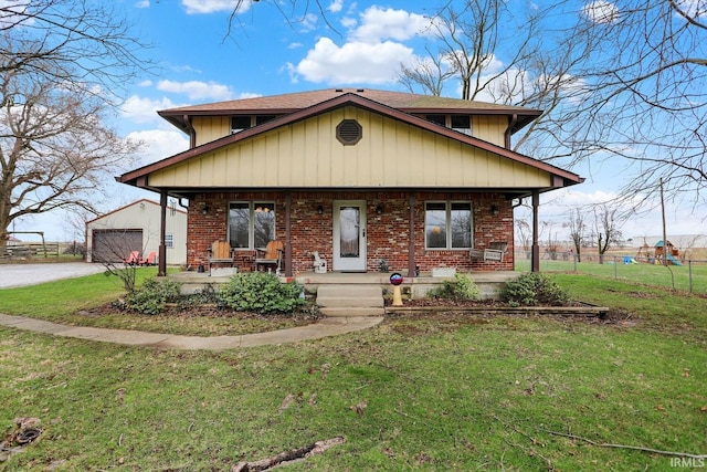 3806 S State Road 3, New Castle, IN 47362 - view of front facade featuring a porch, a detached garage, fence, brick siding, and a front yard