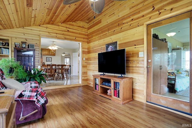 3806 S State Road 3, New Castle, IN 47362 - living area featuring lofted ceiling, wood finished floors, a ceiling fan, and wood walls