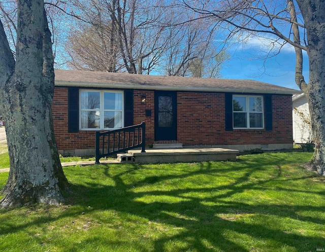 ranch-style home featuring a front yard, brick siding, and crawl space