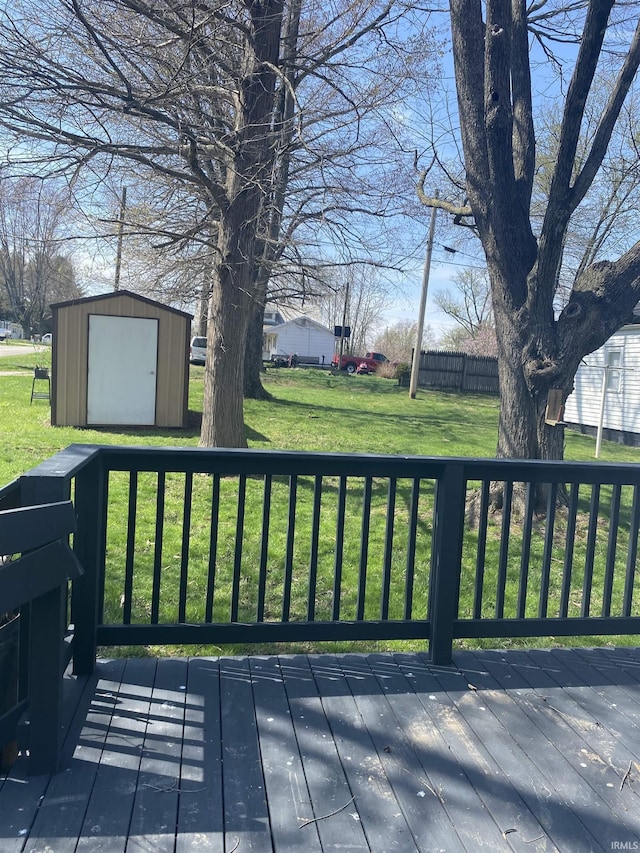 deck featuring a yard, an outdoor structure, and a storage unit