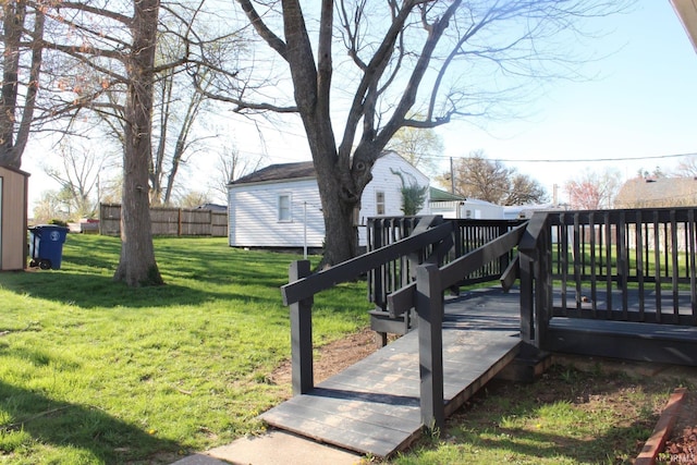 view of yard with a deck and fence