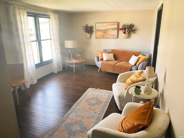 living room with plenty of natural light, wood finished floors, and a textured ceiling