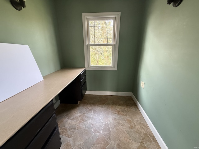 408 N 8th St, Petersburg, IN 47567 - unfurnished office featuring built in desk, stone finish floors, and baseboards