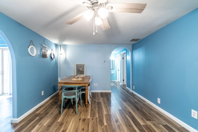 11910 E 690 S, Hudson, IN 46747 - dining space featuring baseboards, ceiling fan, visible vents, wood finished floors, and arched walkways