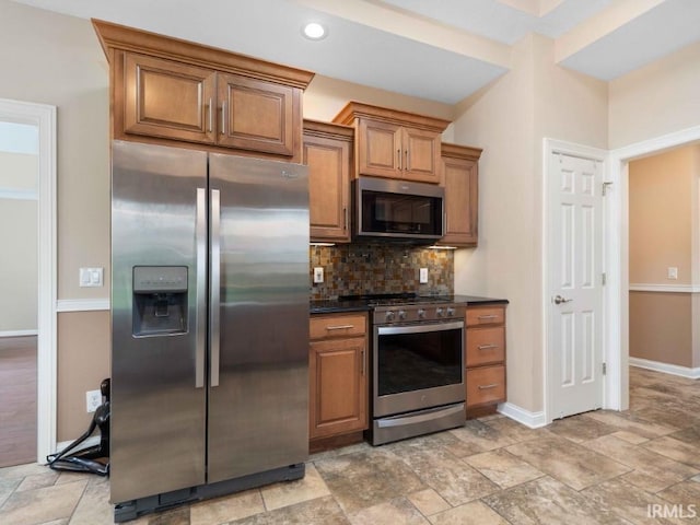 1817 Prestwick Ln, Fort Wayne, IN 46814 - kitchen with brown cabinets, dark countertops, baseboards, appliances with stainless steel finishes, and decorative backsplash