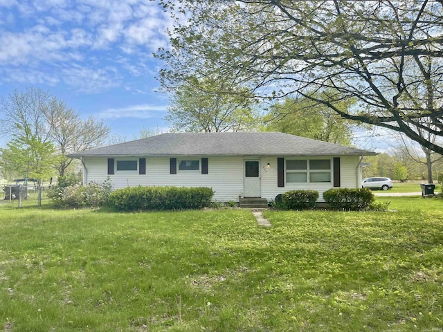 ranch-style house featuring a front yard, fence, and entry steps