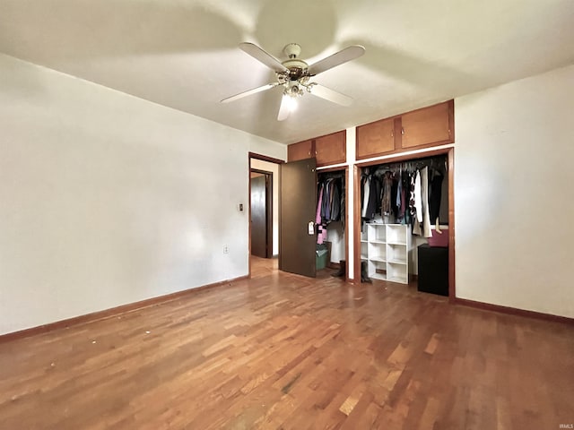 unfurnished bedroom featuring wood finished floors, baseboards, and ceiling fan