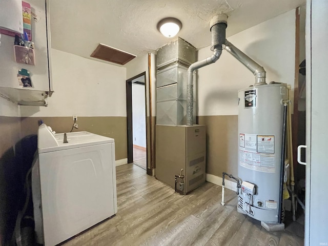 washroom featuring separate washer and dryer, laundry area, gas water heater, baseboards, and light wood-style floors