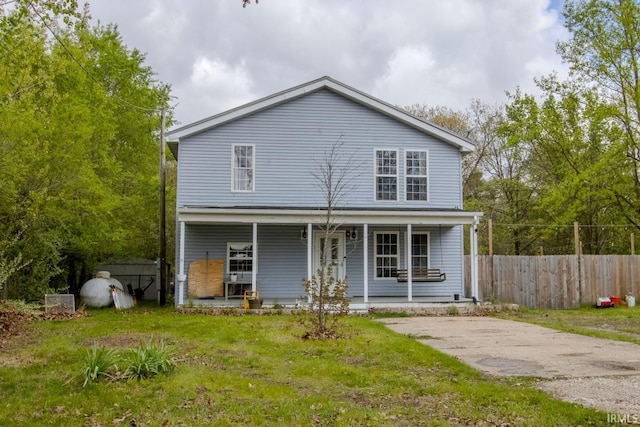 12190 W County Line Rd, Plymouth, IN 46563 - traditional-style home with a porch, fence, and a front lawn