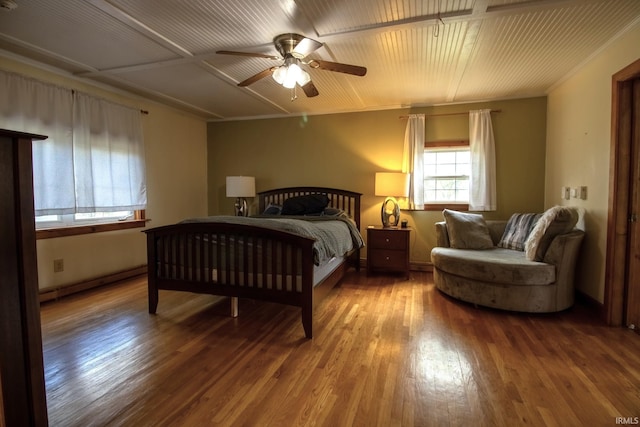 12190 W County Line Rd, Plymouth, IN 46563 - bedroom with ceiling fan, baseboards, baseboard heating, and wood finished floors