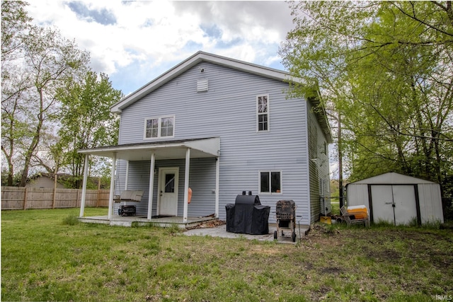 12190 W County Line Rd, Plymouth, IN 46563 - back of house with fence, a patio, an outbuilding, a shed, and a lawn