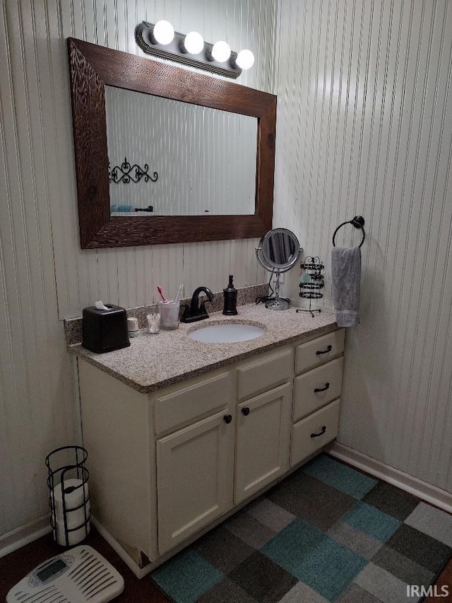 337 W White Pine Ct, Bloomington, IN 47403 - bathroom featuring wooden walls, tile patterned floors, and vanity