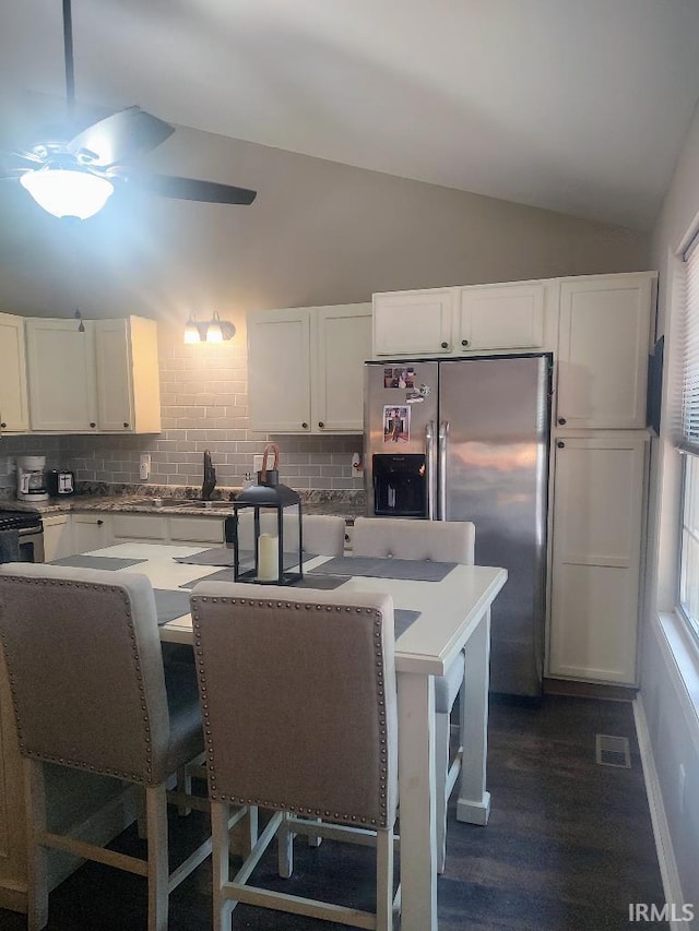 337 W White Pine Ct, Bloomington, IN 47403 - kitchen featuring lofted ceiling, backsplash, stainless steel fridge, and visible vents
