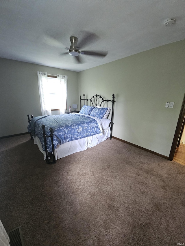 bedroom with visible vents, baseboards, ceiling fan, and carpet floors