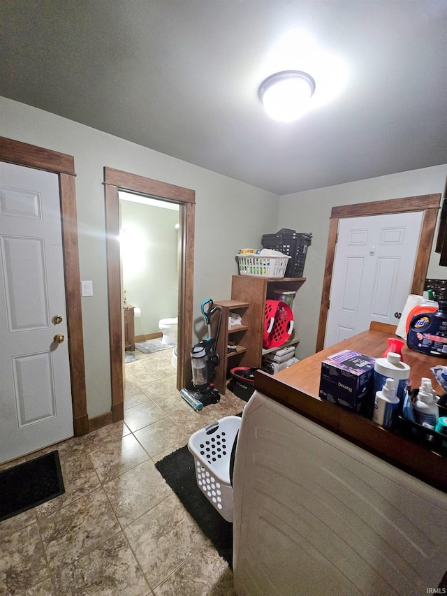 bedroom featuring ensuite bath and tile patterned floors