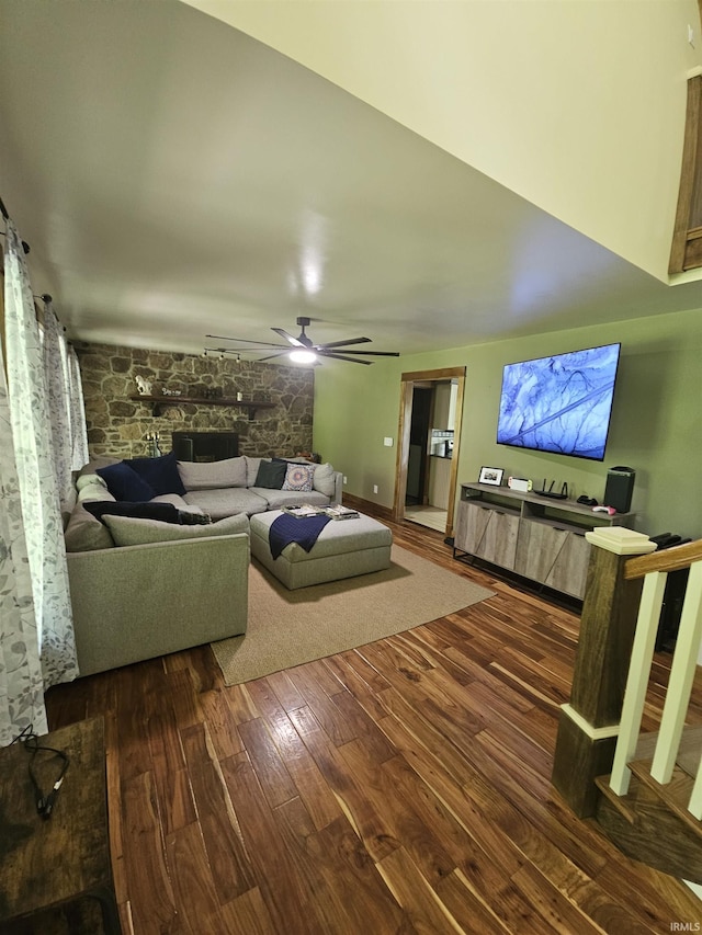living area featuring a ceiling fan and hardwood / wood-style flooring